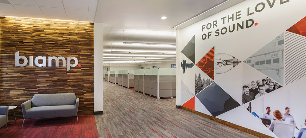 Biamp office lobby interior with branded wall signage and “For the Love of Sound” mural, modern corporate workspace entrance area