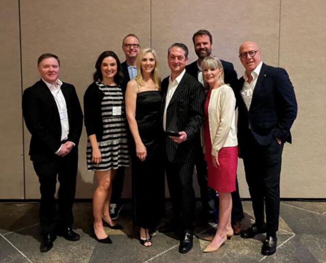 Image of Biamp President, CEO & Co-Chairman Rashid Skaf and management team members accept the 2023 Oregon Technology Association Enterprise Award.