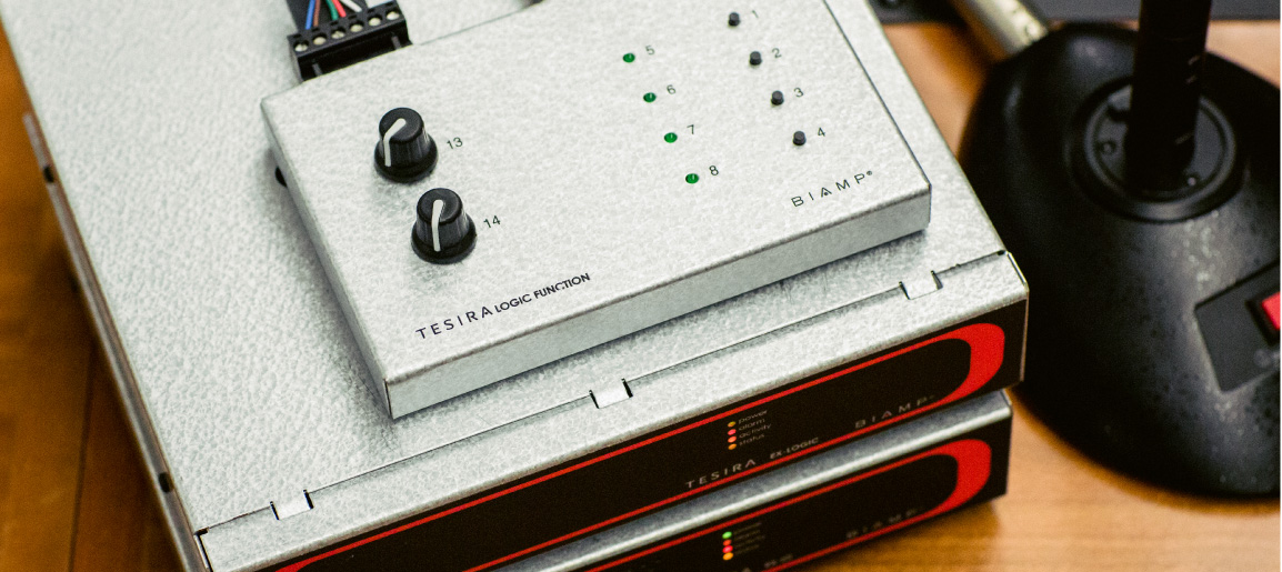Biamp Tesira audio DSP equipment stack with logic control panel and status LEDs, used for professional AV system integration and sound processing