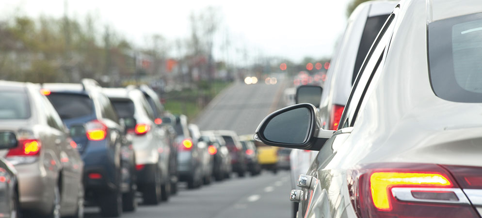 Traffic jam with cars lined up on roadway, congested commute and urban transportation delay concept