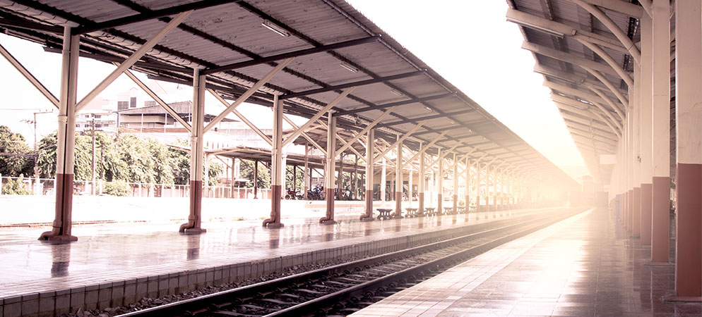 Empty train station platform with railway tracks and covered shelter, public transportation terminal and travel commute concept