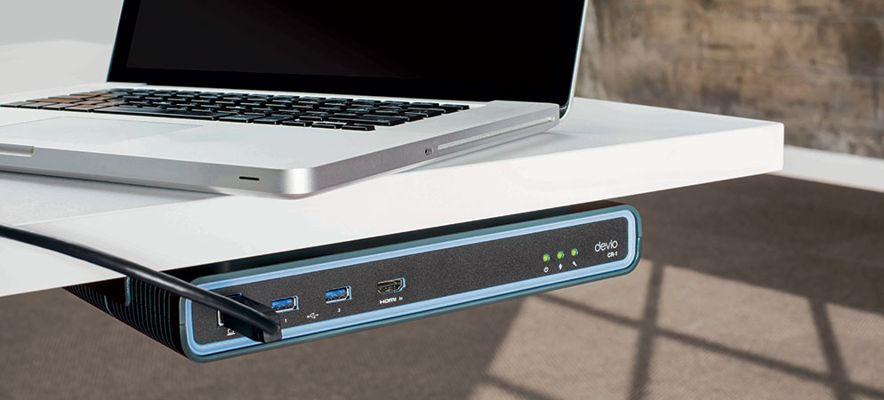 Laptop connected to Biamp Devio CR-1 under-table conferencing hub with USB and HDMI ports for streamlined meeting room AV setup