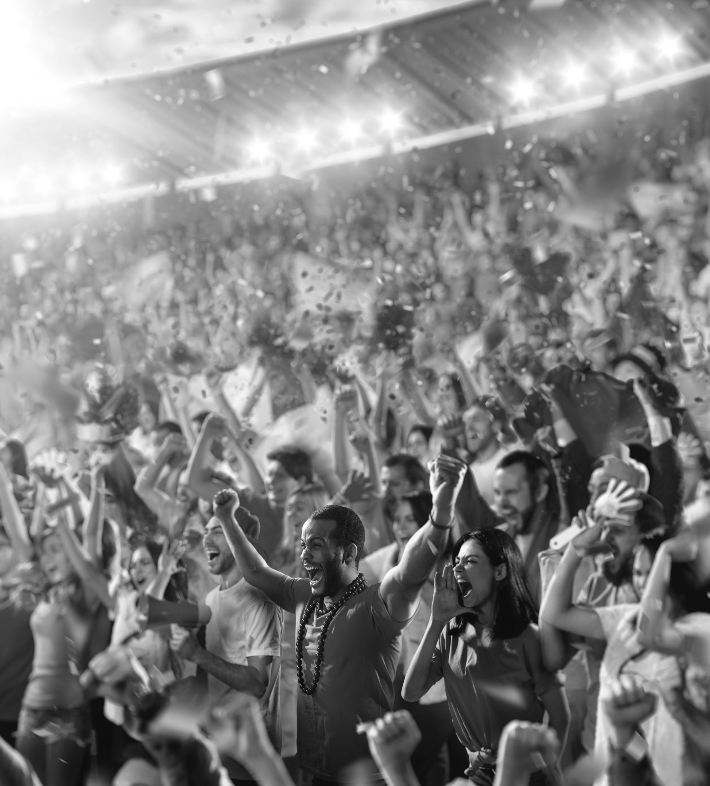 Cheering stadium crowd celebrating with raised arms and confetti, high-energy live event audience at sports game or concert in arena.