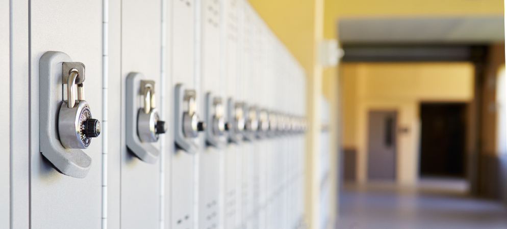 Close-up of school lockers with combination padlocks in a hallway, highlighting student storage and campus security concept