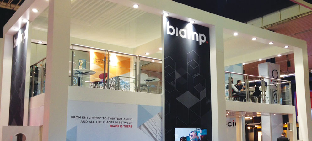 Biamp trade show booth with two-level exhibition stand, branded signage, and meeting area showcasing professional audio solutions at expo