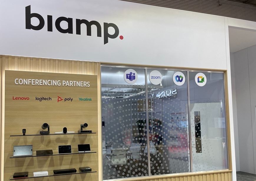 Biamp trade show booth showcasing conferencing partners and video collaboration solutions with Microsoft Teams and Zoom signage