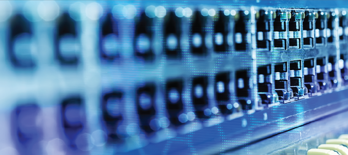 Close-up of network switch ports in data center rack with blue lighting, highlighting enterprise IT infrastructure and high-speed connectivity