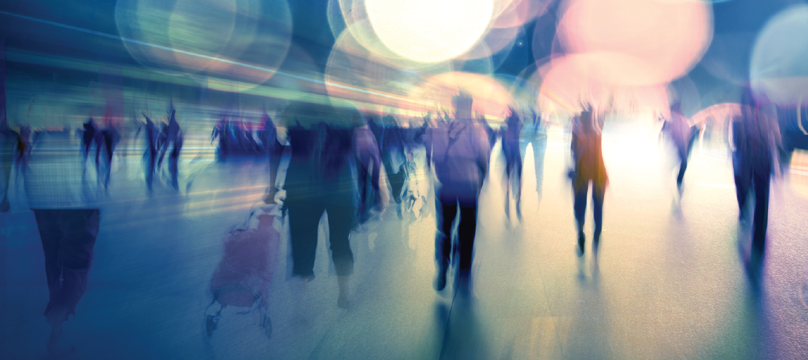 Abstract motion-blur crowd walking through airport or convention center, vibrant bokeh lights, busy travel and event hallway background.