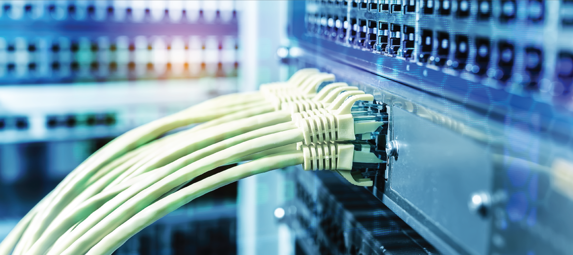 Close-up of Ethernet cables plugged into network switch in server rack, illustrating data center connectivity and IT infrastructure management