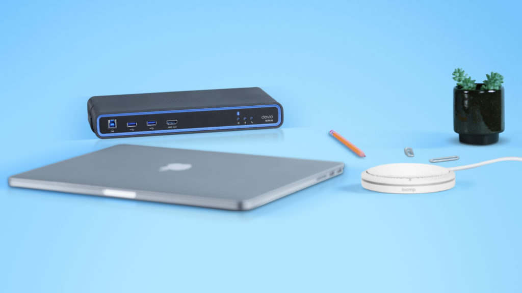 Image of a laptop, desktop flat speaker and a Devio meeting room hub.