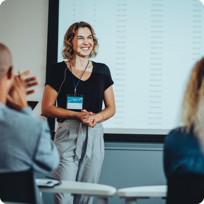 Person giving a presentation while wearing a headset microphone.