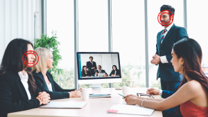 Group sitting around a screen in a conference room.