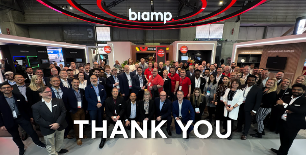 ISE 2026 Biamp trade show booth group photo with “Thank You” message, event team and attendees gathered on exhibition floor