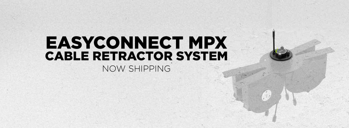 EasyConnect MPX cable retractor system now shipping banner with tabletop cable management device shown in installation view