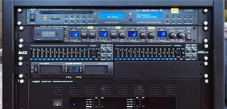 Rack-mounted professional audio system with CD/Bluetooth player, mixers, equalizer and power amplifier controls.