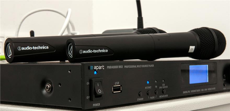 Professional audio setup featuring two wireless microphones on a rack-mount mixer.