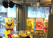 Retail store interior featuring SpongeBob SquarePants merchandise and themed yellow apparel displays