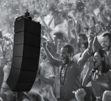 Biamp line array loudspeaker system delivering powerful sound to cheering crowd in packed stadium