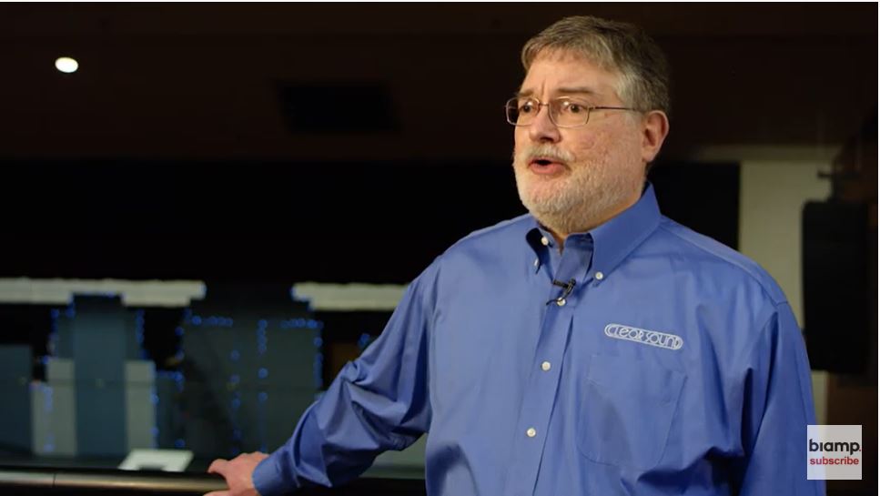 Man in Clear Sound logo shirt giving testimonial about Biamp Community loudspeakers in performance venue