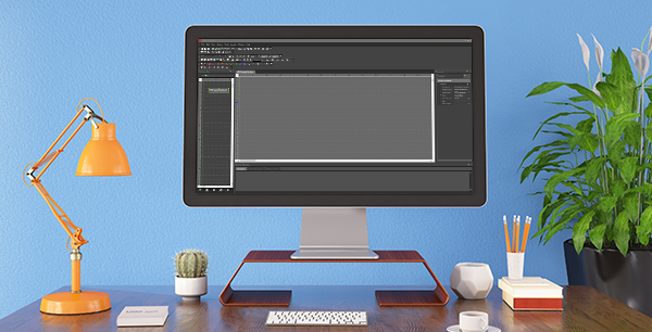 Home office desk with desktop monitor running Biamp Tesira software, orange lamp and plants against blue wall
