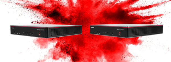 Two Biamp Devio SCX audio processors are featured against a dramatic explosion of red powder.