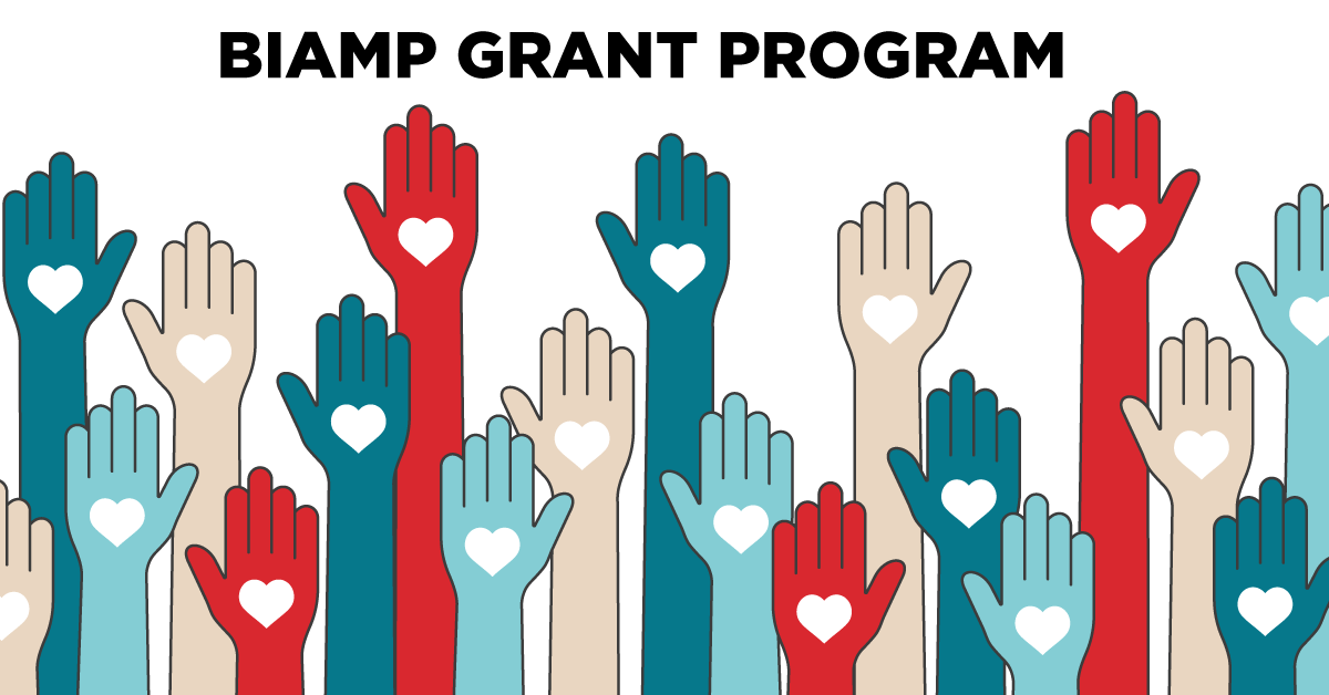 Biamp Grant Program graphic featuring colorful raised hands with heart icons, symbolizing support for community projects through audiovisual technology grants.