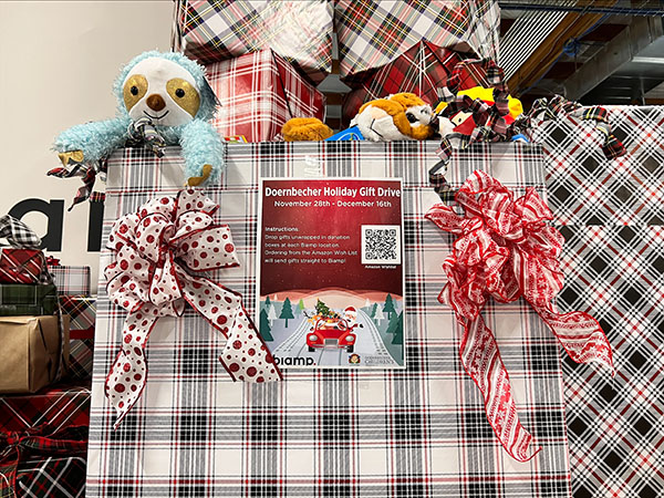 A festive display of wrapped gifts, bows, and stuffed animals for the Doernbecher Holiday Gift Drive.