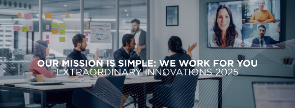 Modern conference room with team in a hybrid meeting, large display showing remote participants and text: “Our mission is simple: we work for you – Extraordinary Innovations 2025.”