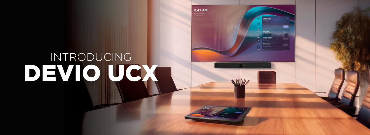 Introducing Devio UCX in modern conference room with display, video bar, and tabletop controller for UC meetings