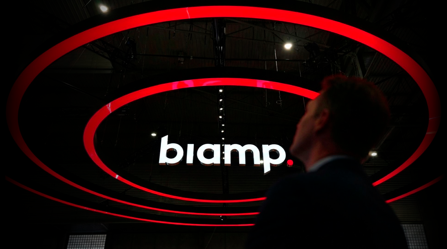 Biamp trade show booth with glowing red overhead rings and logo display at event venue