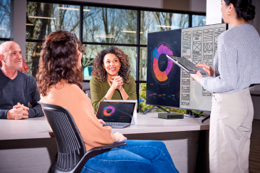Computer displaying Biamp Workplace software in a bright, modern office setting