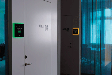 Meeting room door with a green lit evoko naso mounted on the wall