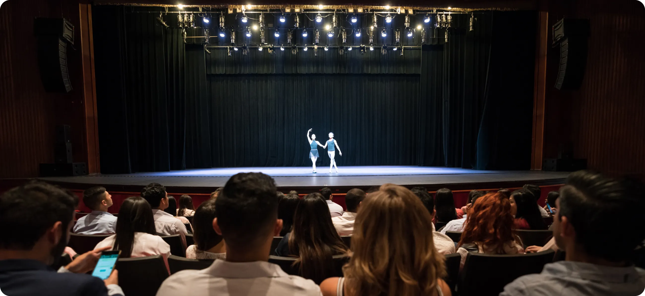 A large theater with a ballet on stage