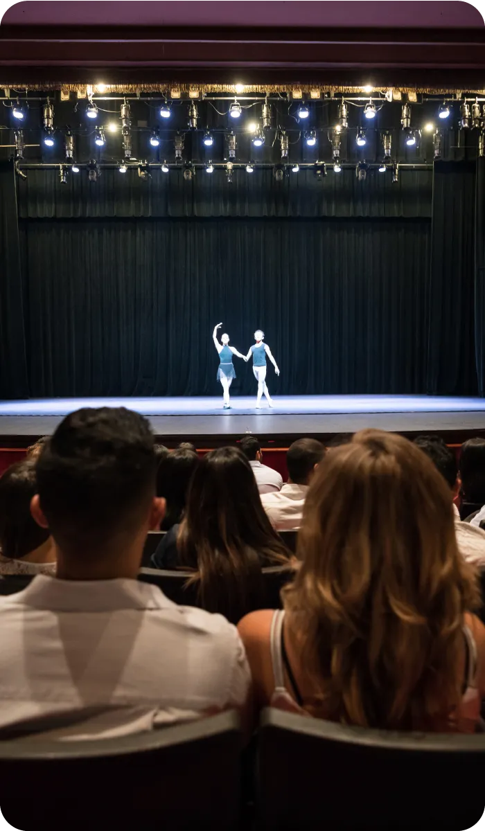 A large theater with a balet on  stage