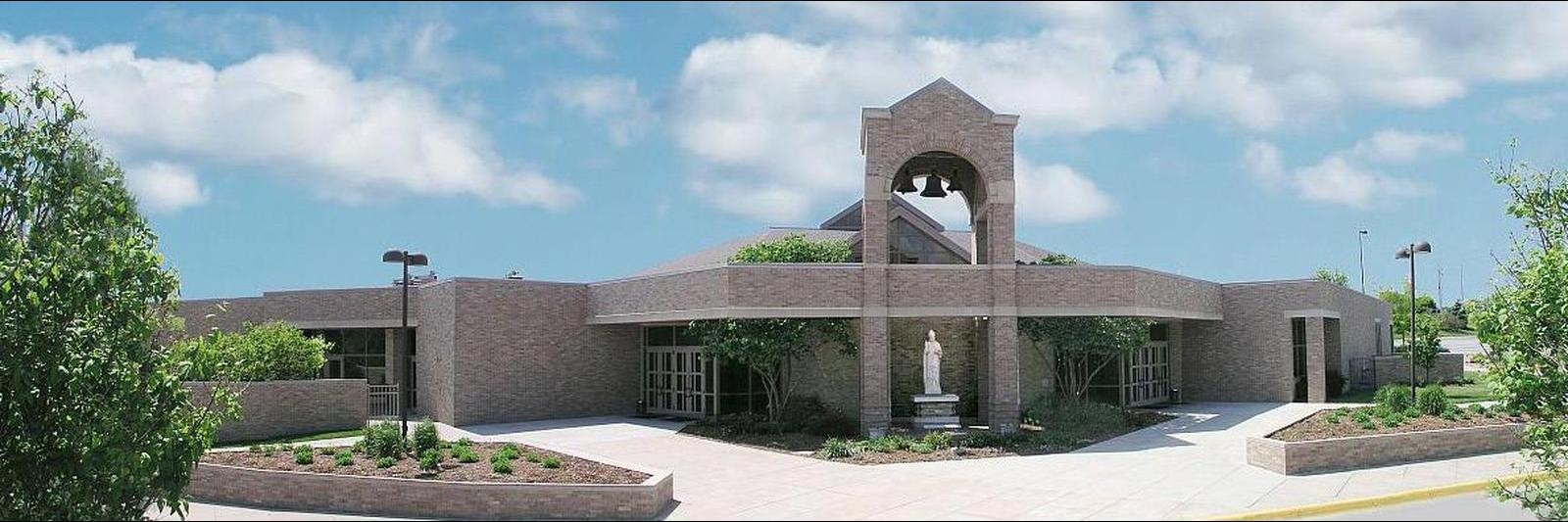 Hero image of Saint Gerald Catholic Church in Ralston, Nebraska, highlighting its ornate glasswork and high ceilings.