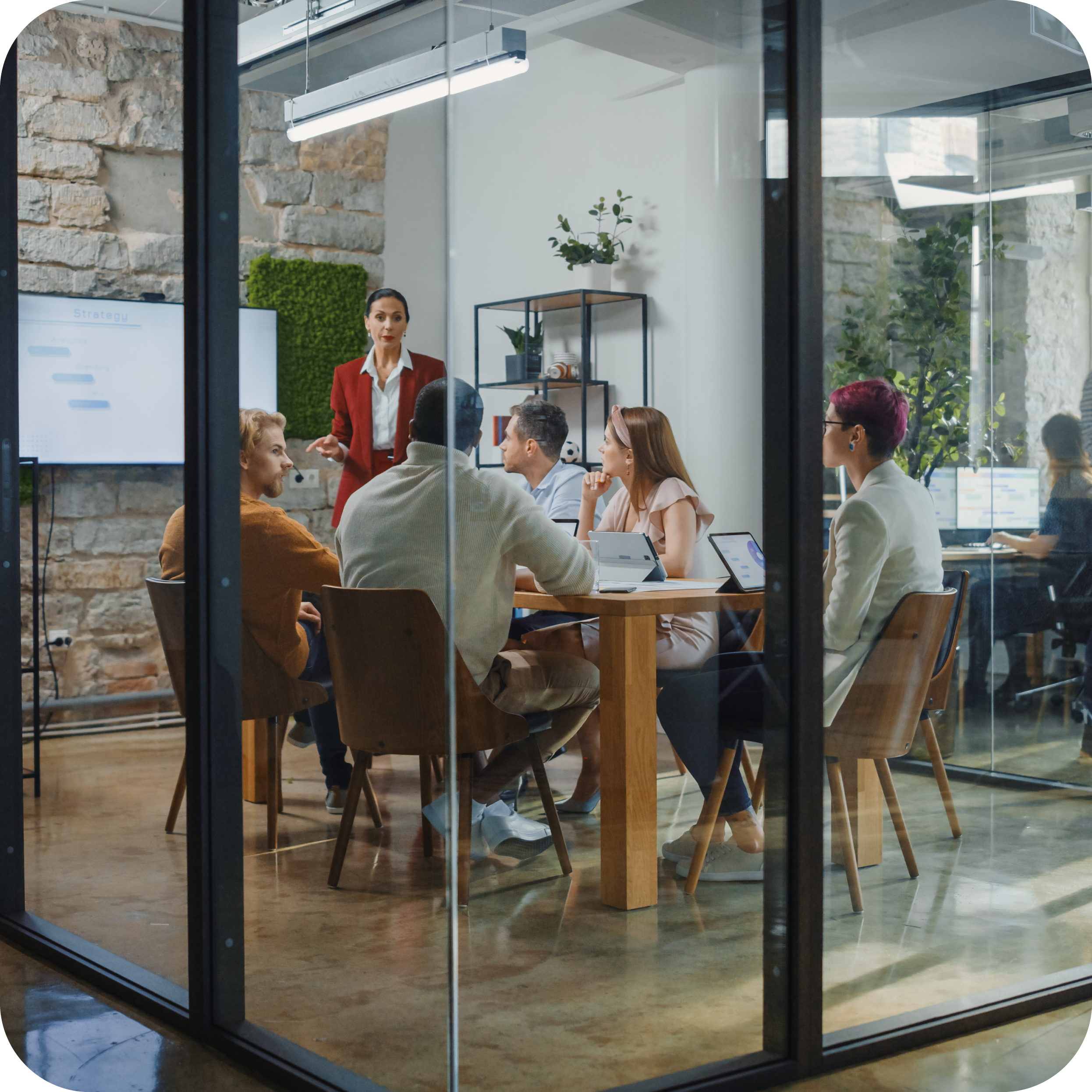 Group collaboration inside an enclosed conference room.