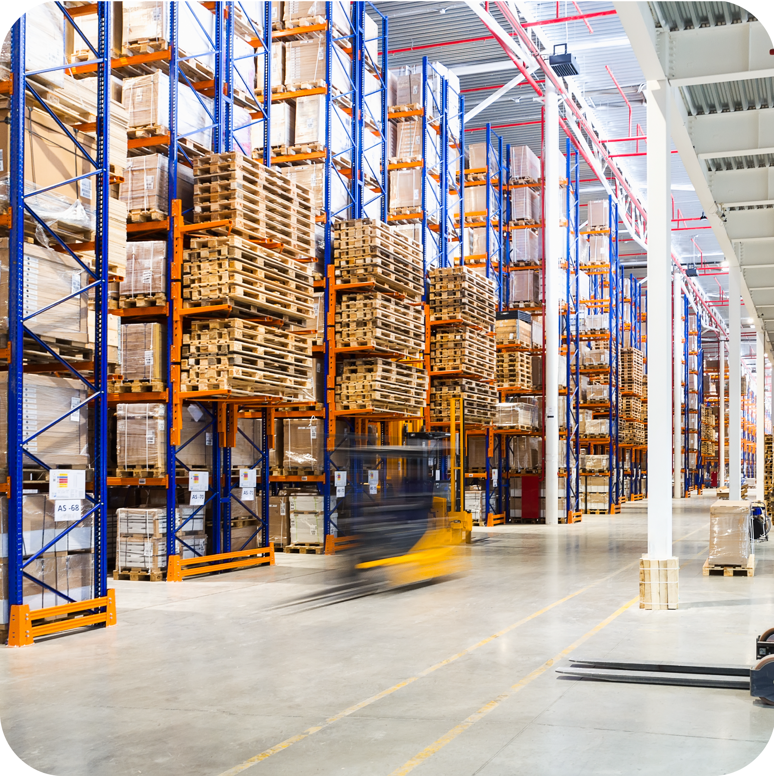 Warehouse with a moving forklift in motion.