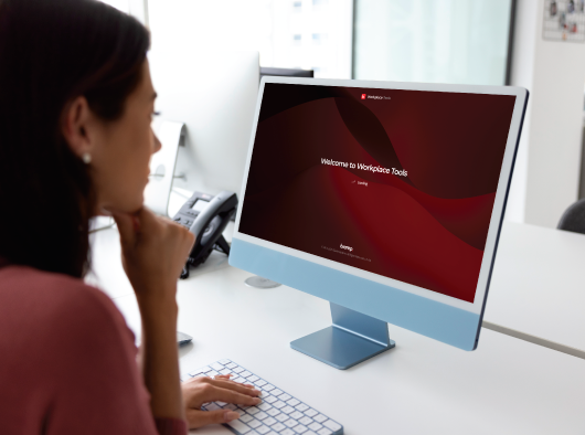 Woman on desktop viewing workplace dashboard 