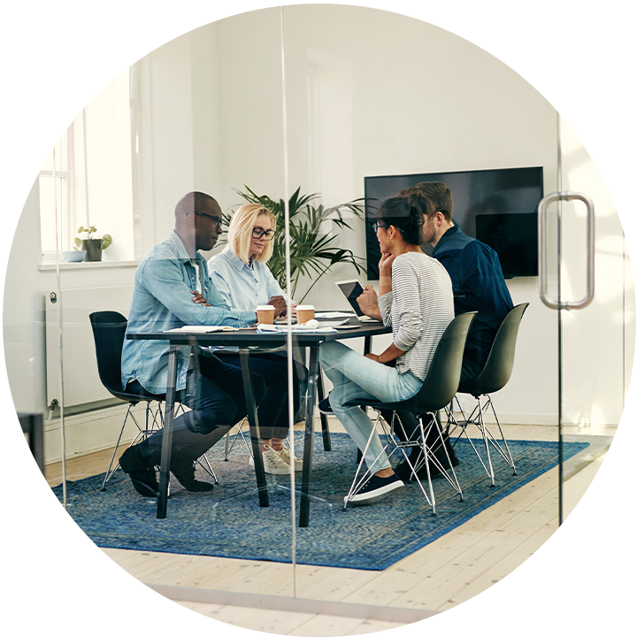 Four people inside meeting room